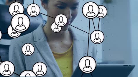 Animation-of-network-of-digital-icons-over-businesswoman-in-office