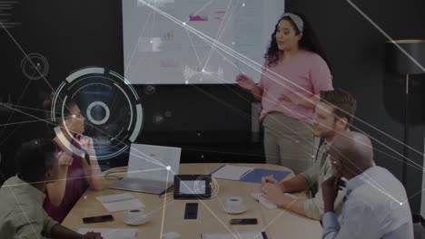 Animation-of-circles-and-connected-dots-against-diverse-coworkers-discussing-reports-on-technology