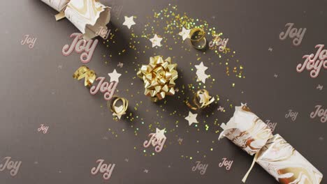 Animation-of-christmas-greetings-text-over-christmas-cracker-decorations