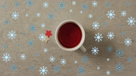 Animation-of-snow-falling-over-christmas-cup-of-tea