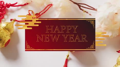 Animation-of-happy-new-year-text-over-chinese-traditional-decorations-on-red-background