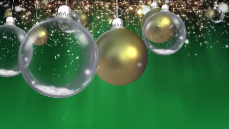 Animation-of-baubles-and-light-spots-over-green-background