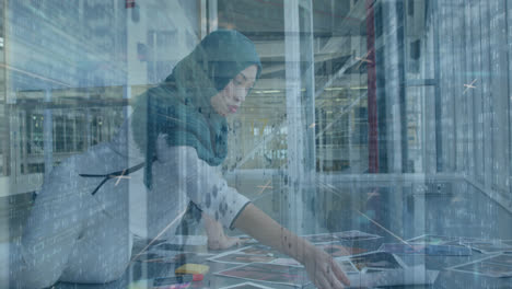 Animation-of-bars,-x-symbols-on-biracial-woman-wearing-hijab-looking-at-pictures-against-server-room
