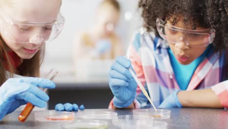 Diverse-happy-schoolchildren-having-science-class-in-school-lab