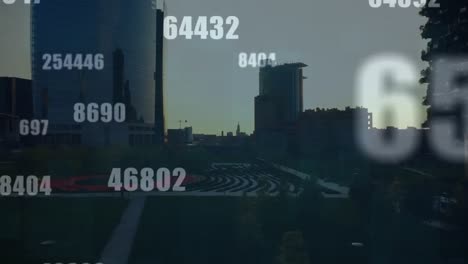 Animation-of-multiple-changing-numbers-and-symbols-against-aerial-view-of-cityscape