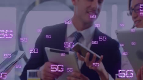 Animation-of-5g-texts-over-caucasian-business-people-using-smartphone