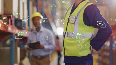 Animation-of-eco-icons-and-data-processing-over-diverse-people-working-in-warehouse