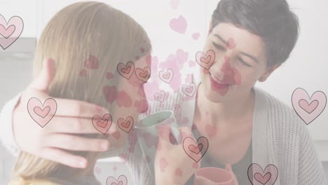 Animation-of-heart-emojis-over-happy-caucasian-female-couple-in-love-embracing