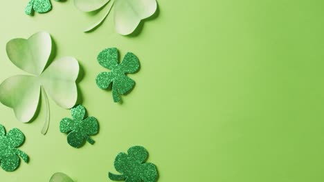 Video-of-saint-patricks-day-green-shamrock-leaves-with-copy-space-on-green-background