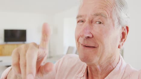 Portrait-of-happy-caucasian-senior-man-talking-and-having-video-call
