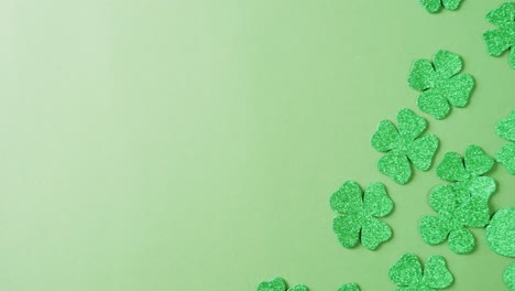 Video-of-st-patrick's-green-shamrock-leaves-with-copy-space-on-green-background