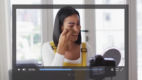 Animation-of-screen-interface-over-biracial-woman-on-makeup-vlog