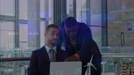Animation-of-stock-market-data-processing-over-two-diverse-businessmen-discussing-at-office