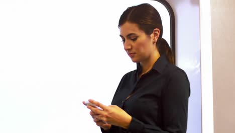 Animation-of-mathematical-equations-over-caucasian-businesswoman-using-smartphone