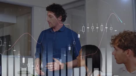 Animation-of-graphs,-numbers-over-diverse-man-explaining-strategy-to-coworkers-on-laptop-in-office