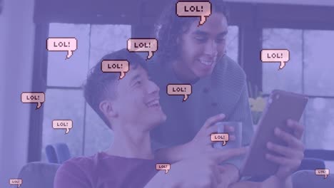 Animation-of-lol-text-in-speech-bubbles-over-diverse-male-couple-using-tablet