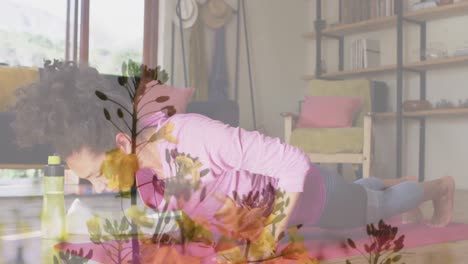Animation-of-flowers-over-woman-exercising-at-home