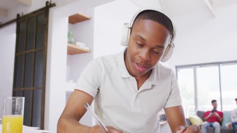 Portrait-of-happy-african-american-male-teenage-boy-having-video-call-at-home,-slow-motion