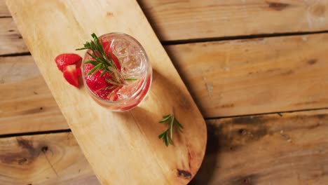 Close-up-of-drink-with-strawberries-on-wooden-board,-with-copy-space