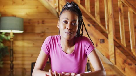 Happy-african-american-woman-sitting-at-table-and-having-video-call,-slow-motion