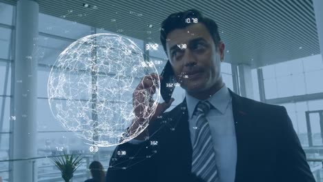 Animation-of-numbers-around-rotating-globe-over-caucasian-man-talking-on-smartphone-at-office