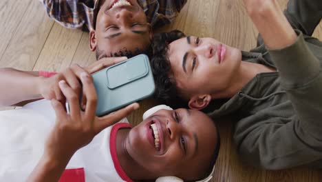 Video-of-happy-diverse-male-teenage-friends-using-smartphones,-slow-motion