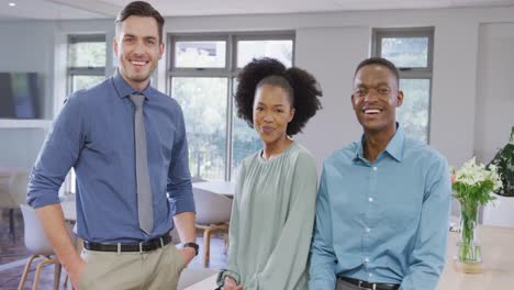 Portrait-of-happy-diverse-business-people-looking-at-camera-and-smiling-at-office,-slow-motion