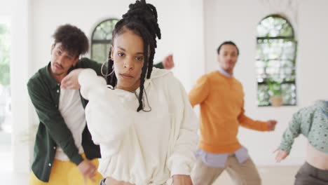 Portrait-of-happy-diverse-male-and-female-dancers-dancing-in-dance-studio,-slow-motion
