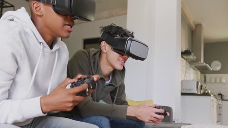 Happy-diverse-male-teenage-friends-playing-video-games-and-using-vr-headsets-at-home,-slow-motion