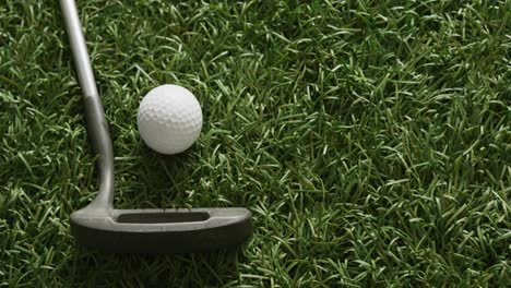 Close-up-of-golf-club-and-balls-on-grass,-copy-space,-slow-motion
