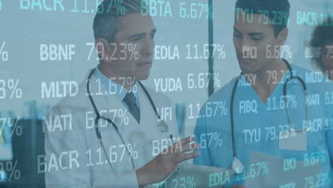 Animation-of-stock-market-data-processing-over-two-diverse-male-doctors-discussing-at-hospital