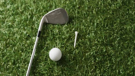 Close-up-of-golf-club-and-ball-on-grass,-copy-space,-slow-motion