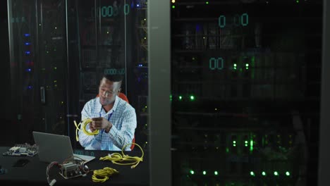 Animation-of-data-processing-over-african-american-male-it-engineer-and-computer-servers