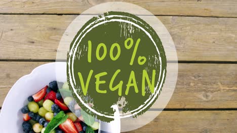 Video-of-100-percent-vegan-text-over-bowl-of-fresh-fruit