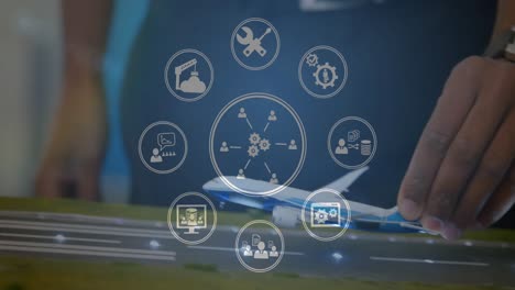 Animation-of-digital-icons-spinning-over-mid-section-of-a-woman-flying-a-airplane-model-at-office