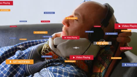 Animation-of-social-media-icons-over-caucasian-senior-man-wearing-headphones-lying-on-the-couch