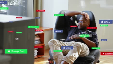 Animation-of-multiple-social-media-icons-over-african-american-man-looking-out-of-window-at-home