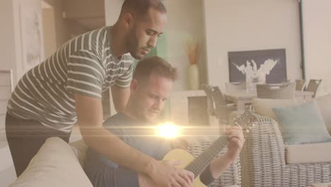 Animation-of-light-trails-over-diverse-male-couple-playing-guitar