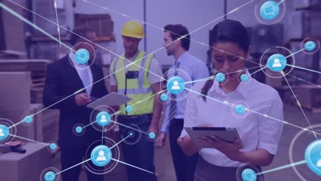 Animation-of-network-of-connections-with-icons-over-diverse-workers-in-warehouse