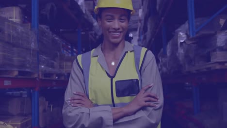 A-young-female-warehouse-worker-smiling-and-looking-directly-at-the-camera
