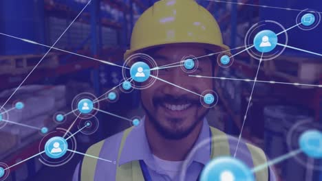 Animation-of-network-of-digital-icons-against-portrait-of-asian-male-worker-smiling-at-warehouse
