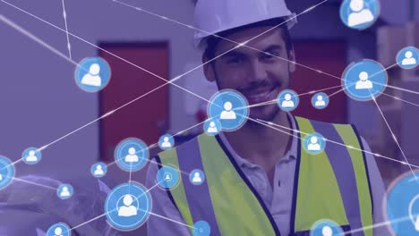 Animation-of-network-of-profile-icons-over-caucasian-male-worker-smiling-at-warehouse