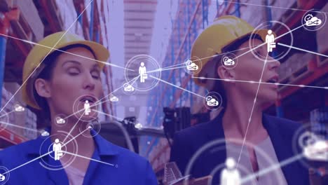 Animation-of-network-of-icons-on-caucasian-female-supervisor-and-worker-checking-stock-at-warehouse
