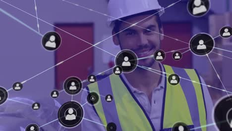 Animation-of-network-of-profile-icons-over-biracial-male-worker-smiling-at-warehouse