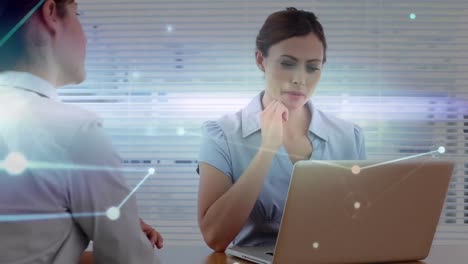 Animation-of-data-processing-over-caucasian-businesswomen-using-laptop