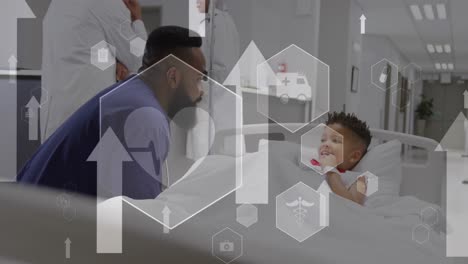 Animation-of-arrows-and-icons-over-diverse-doctor-and-child-patient-at-hospital