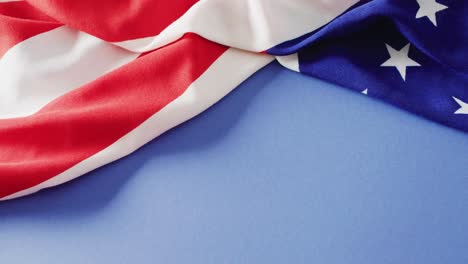 Close-up-of-national-flag-of-usa-on-blue-background-with-copy-space