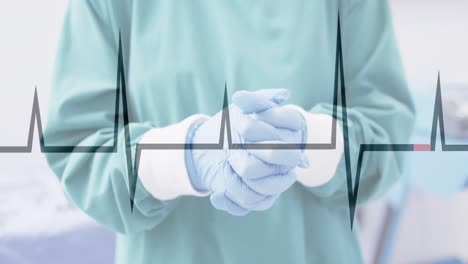 Animation-of-cardiograph-over-surgeon-wearing-medical-gloves-at-hospital