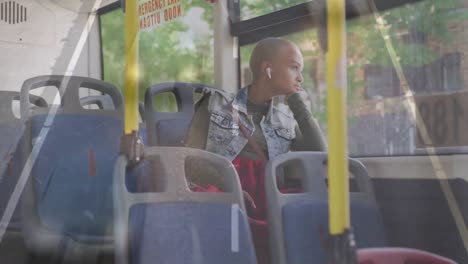 Animation-of-cars-on-street-over-biracial-woman-sitting-in-bus