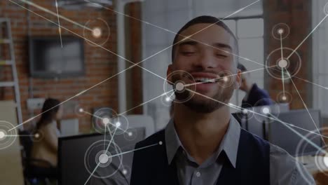 Animation-of-networks-of-connections-over-biracial-businessman-smiling